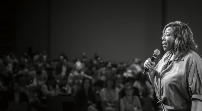 Kimberly speaking on stage